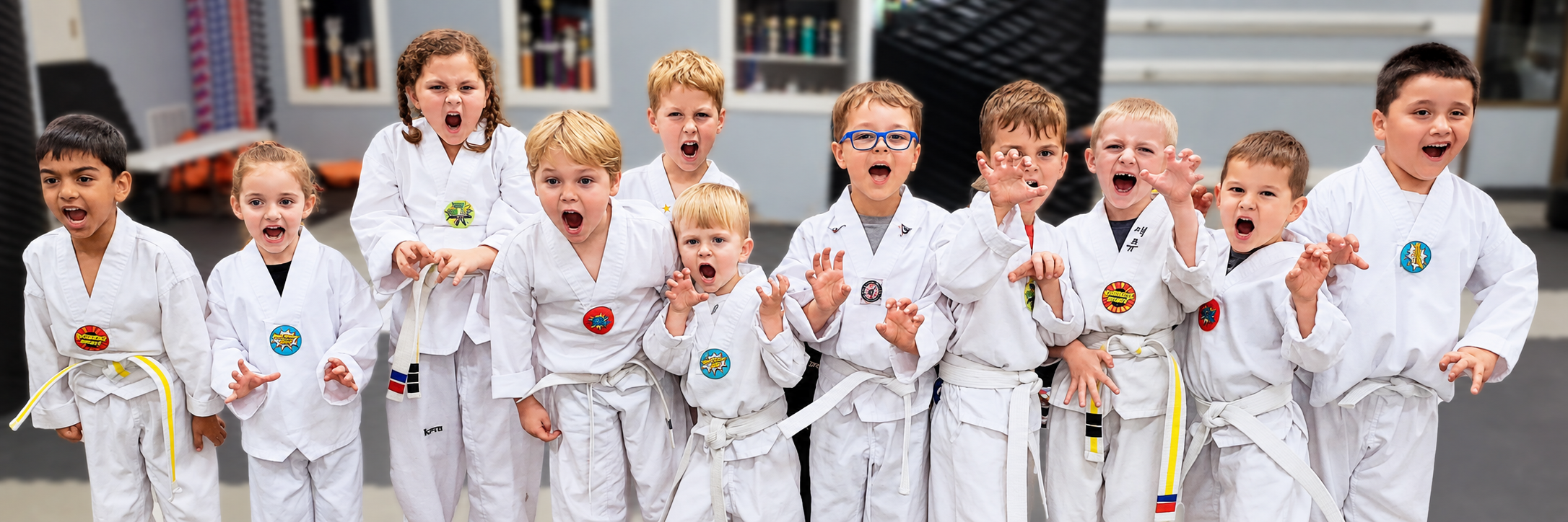 Tiger Tots students making playful tiger claws and roaring together in the dojang.